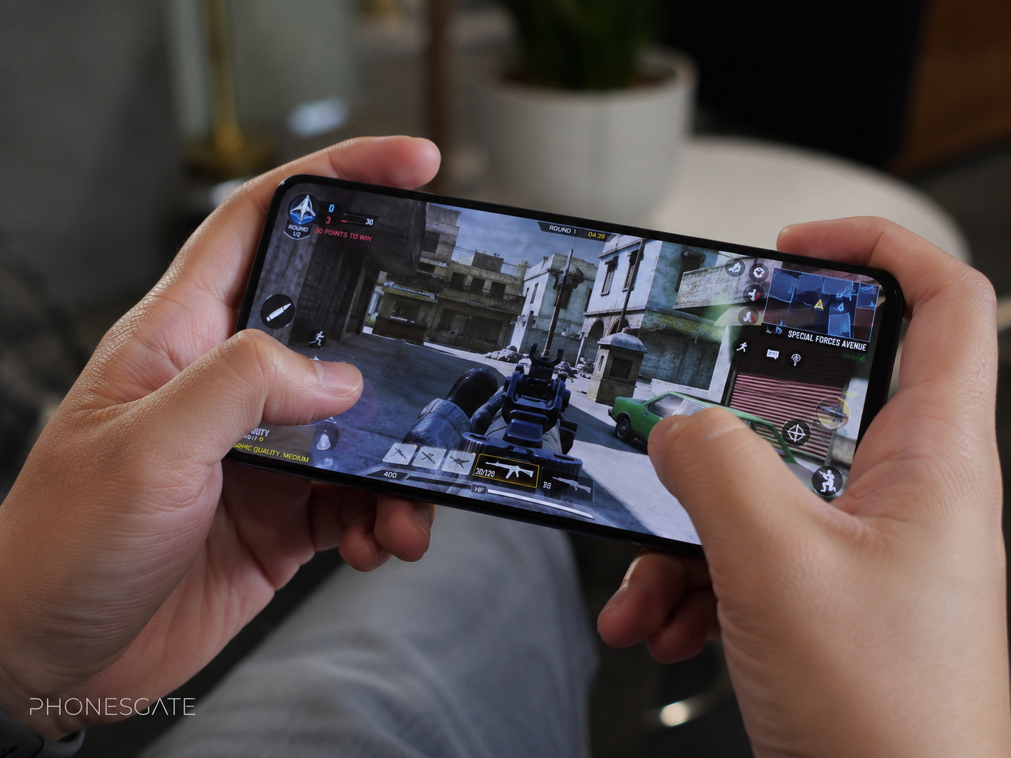 Person using the Nubia Neo 5 GT in a relaxed real-life setting with subtle PhonesGate branding