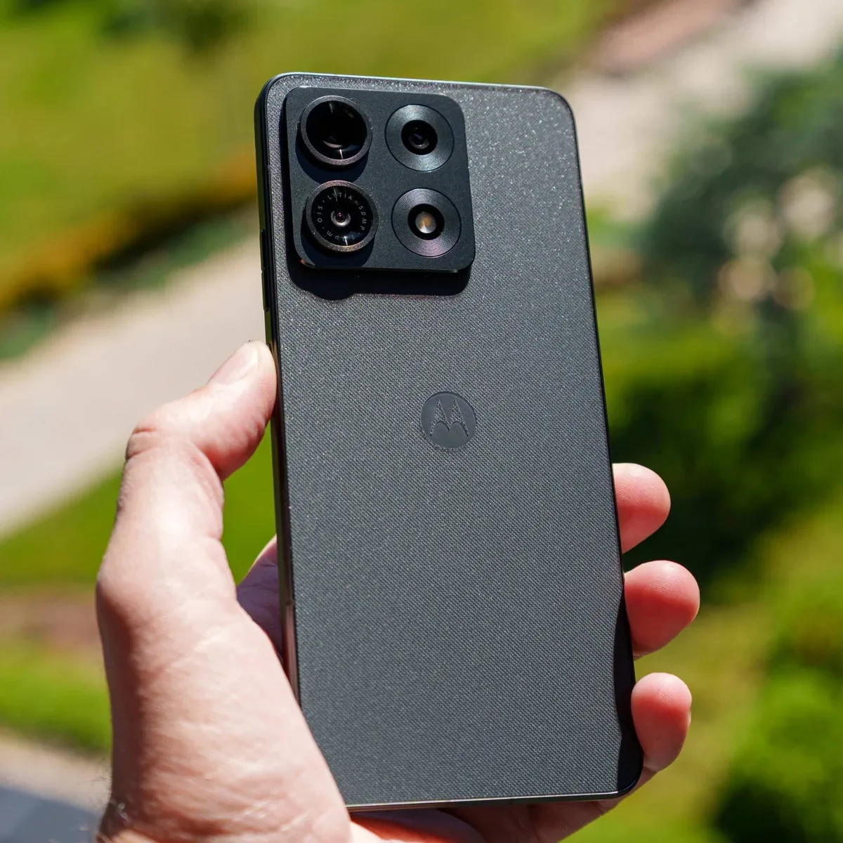 PhonesGate photo of the Moto G86 in hand outdoors