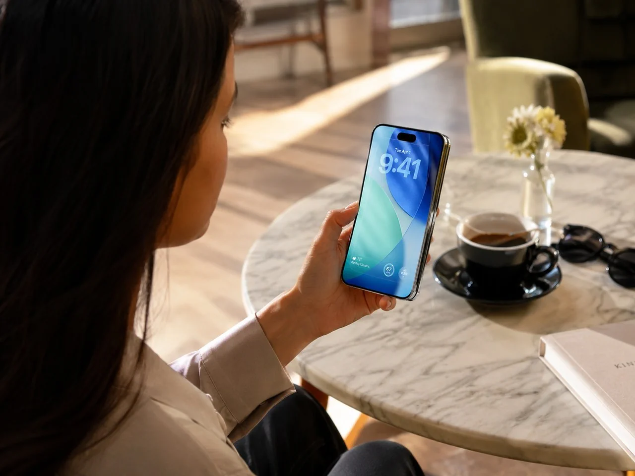 Lifestyle concept showing a person using a compact closed iPhone Fold in a cafe